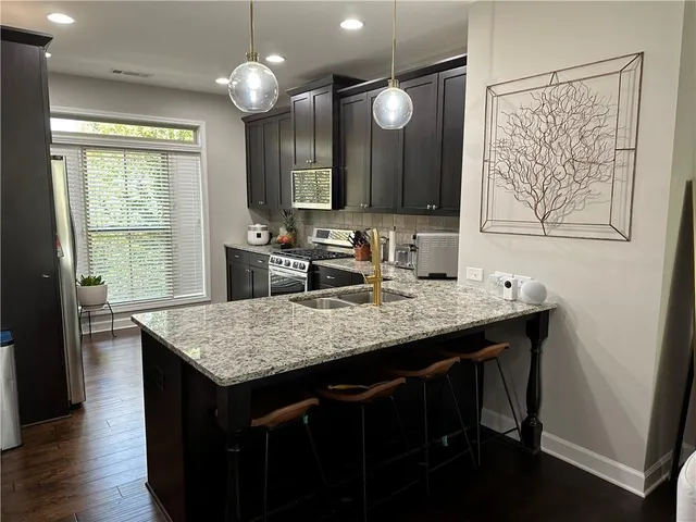 a kitchen with a counter space cabinets and wooden floor