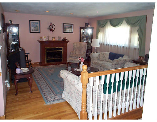 8 Patricia Road Billerica, MA 01821 - Photo 3 of 8 a living room with furniture and a fireplace