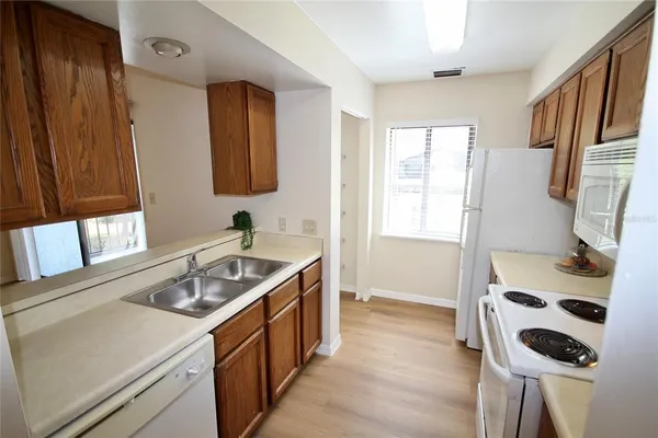 a kitchen with a stove a sink and a refrigerator