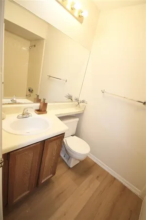 a bathroom with a sink a toilet and vanity