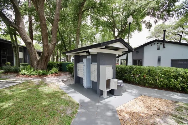 a backyard of a house with table and chairs