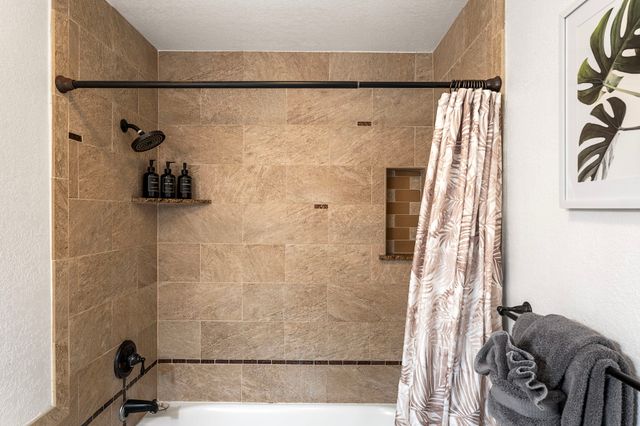 a bathroom with a bathtub and shower