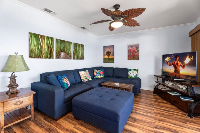 a living room with furniture a rug and a flat screen tv
