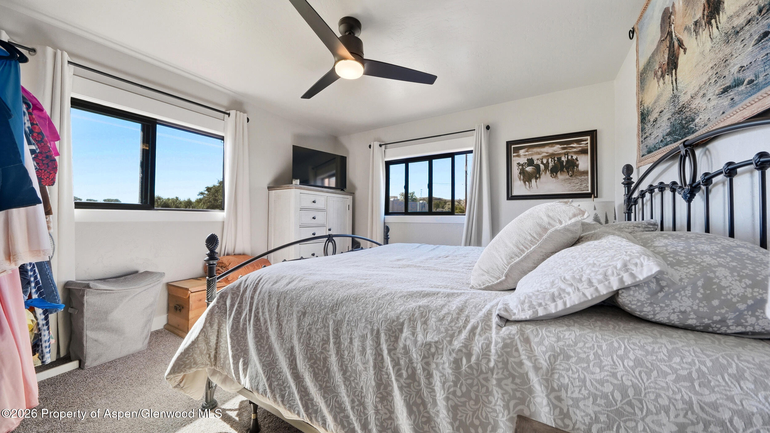 445 South Camp Road Grand Junction, CO 81507 - Photo 23 of 37 a bedroom with a large bed and a chandelier