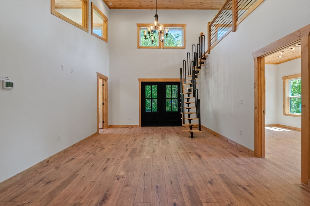 168 Ewing Street Blue Ridge, GA 30513 - Photo 15 of 46 a view of an empty room with wooden floor and a window