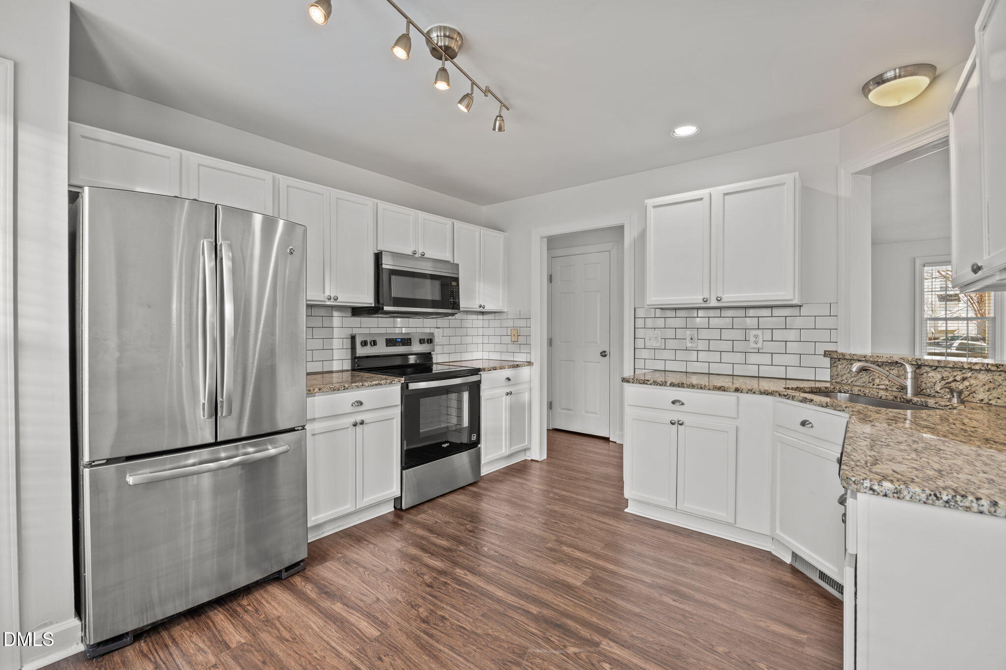 9220 Pennythorne Court Raleigh, NC 27615 - Photo 2 of 49 a kitchen with granite countertop stainless steel appliances a refrigerator cabinets and wooden floor