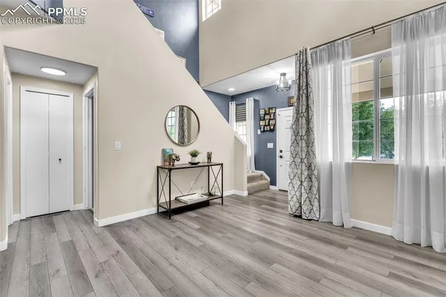 a view of a room with wooden floor and a window