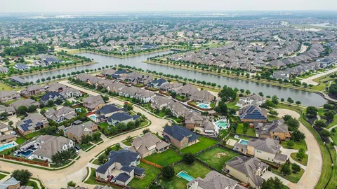 an aerial view of a house with a lake view