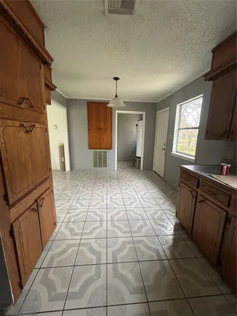 a view of a kitchen with a sink a refrigerator and window