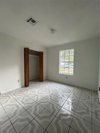 a view of an empty room with windows