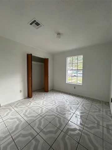 a view of an empty room with windows