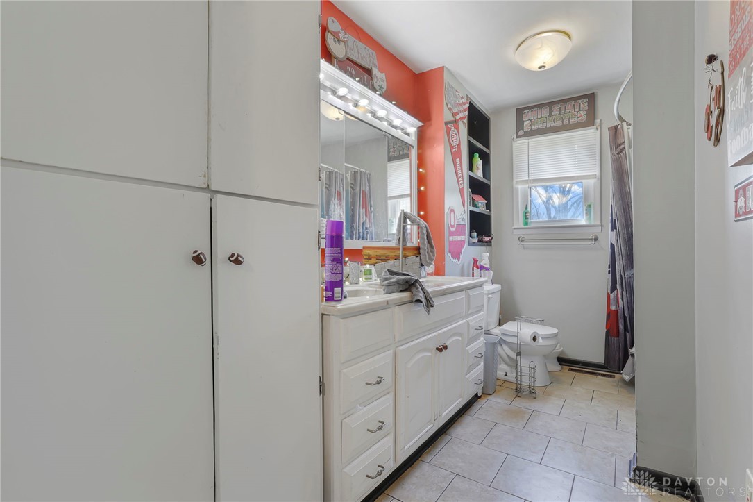 2390 Ridge Road Zanesville, OH 43701 - Photo 16 of 45 Bright and functional bathroom with ample storage and tiled flooring.