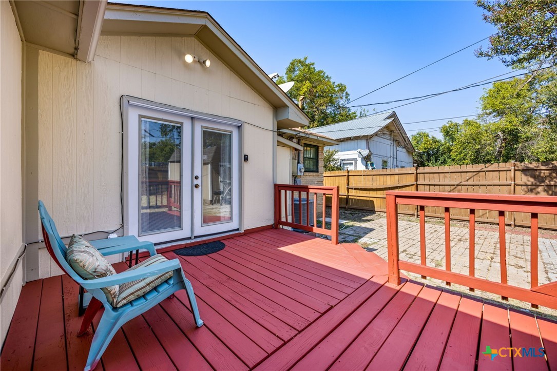 1415 South 9th Street Temple, TX 76504 - Photo 13 of 14 a balcony with wooden floor table and chairs