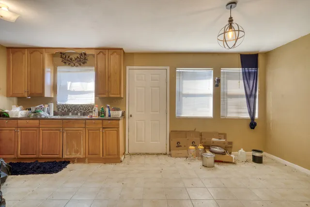 a spacious bathroom with a granite countertop sink and a bathtub