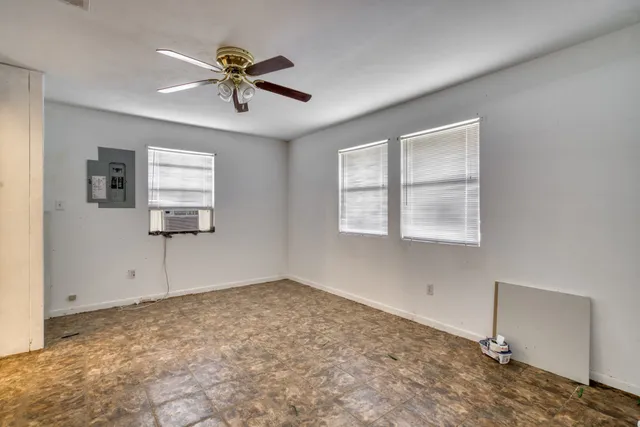 a view of a livingroom with a ceiling fan and window