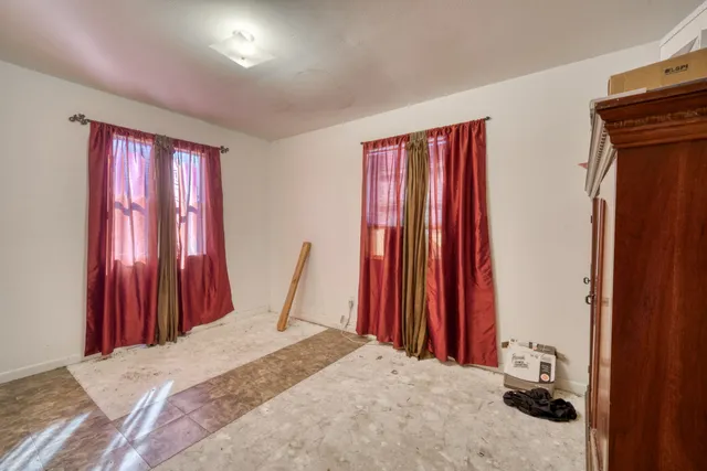 a bed room with a bed and a chair