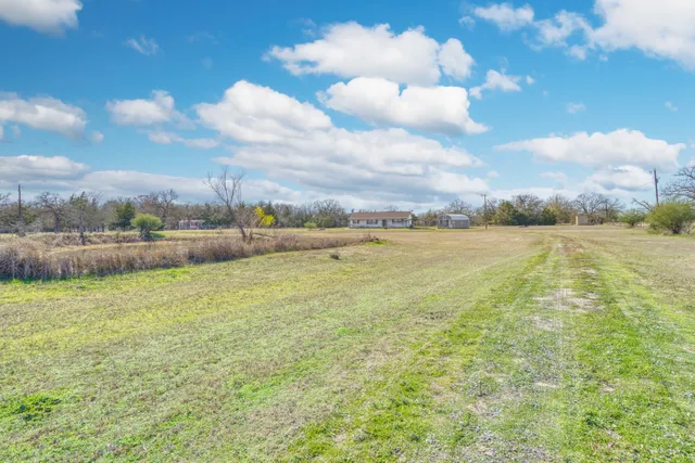 a view of a big yard with an outdoor seating