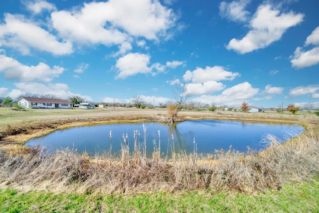 a view of a lake with houses in the back