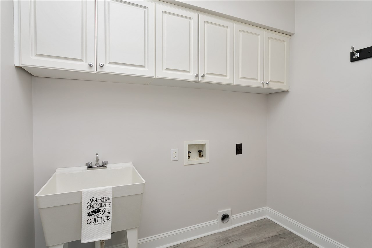 1904 Capers Court Raleigh, NC 27612 - Photo 20 of 29 Updated FIRST FLOOR utility room with built in shelves, laundry- dog or cat wash sink and new floors Laundry
