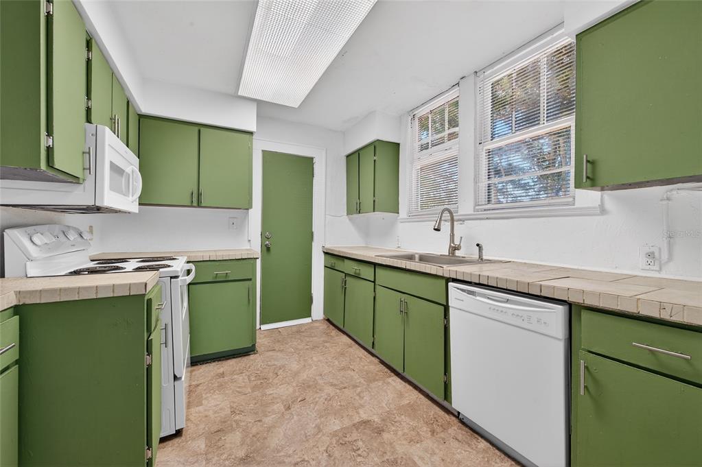 1616 Cres Ridge Road Daytona Beach, FL 32118 - Photo 14 of 40 a kitchen with stainless steel appliances granite countertop a sink and a stove
