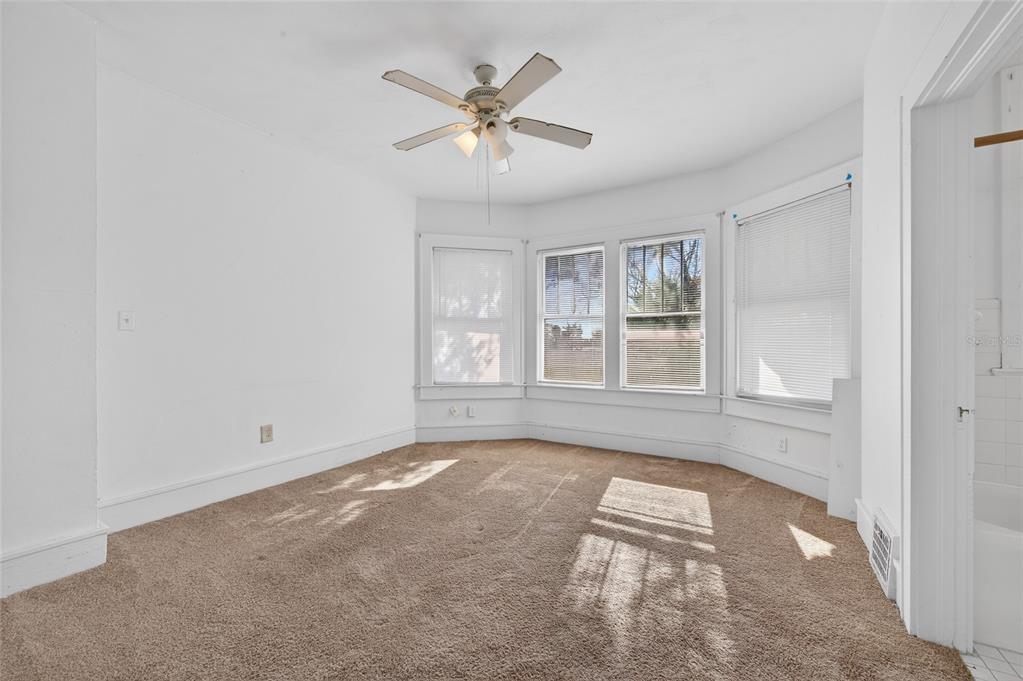1616 Cres Ridge Road Daytona Beach, FL 32118 - Photo 16 of 40 an empty room with windows and fan