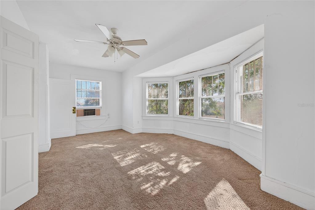 1616 Cres Ridge Road Daytona Beach, FL 32118 - Photo 21 of 40 an empty room with windows and ceiling fan