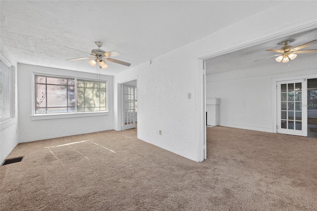 1616 Cres Ridge Road Daytona Beach, FL 32118 - Photo 10 of 40 an empty room with windows and ceiling fan
