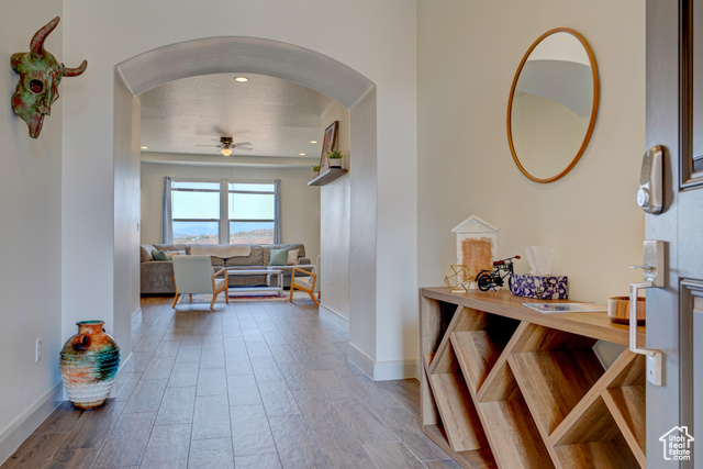 1329 Paseos Street Washington, UT 84780 - Photo 4 of 35 Hall with arched walkways, light wood finished floors, and recessed lighting