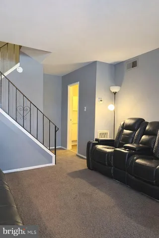 a living room with furniture window and wooden floor
