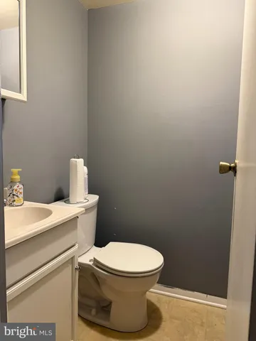 a white toilet sitting next to a white sink