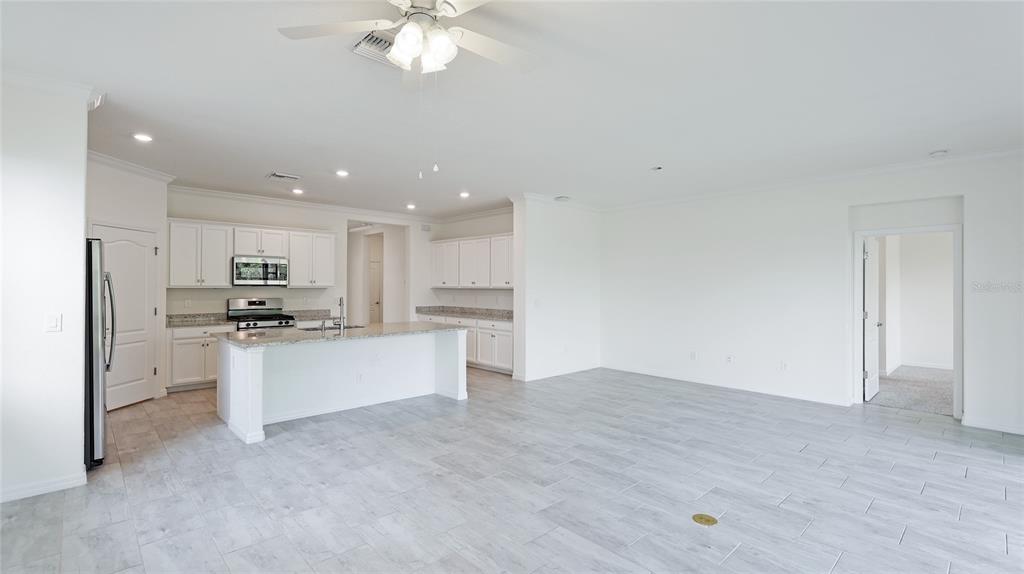 17311 Blue Ridge Place Bradenton, FL 34211 - Photo 13 of 55 a kitchen with stainless steel appliances kitchen island granite countertop a refrigerator and a stove top oven