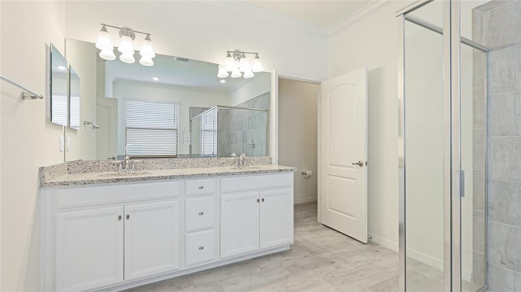 17311 Blue Ridge Place Bradenton, FL 34211 - Photo 19 of 55 a bathroom with a granite countertop double vanity sink shower and a mirror