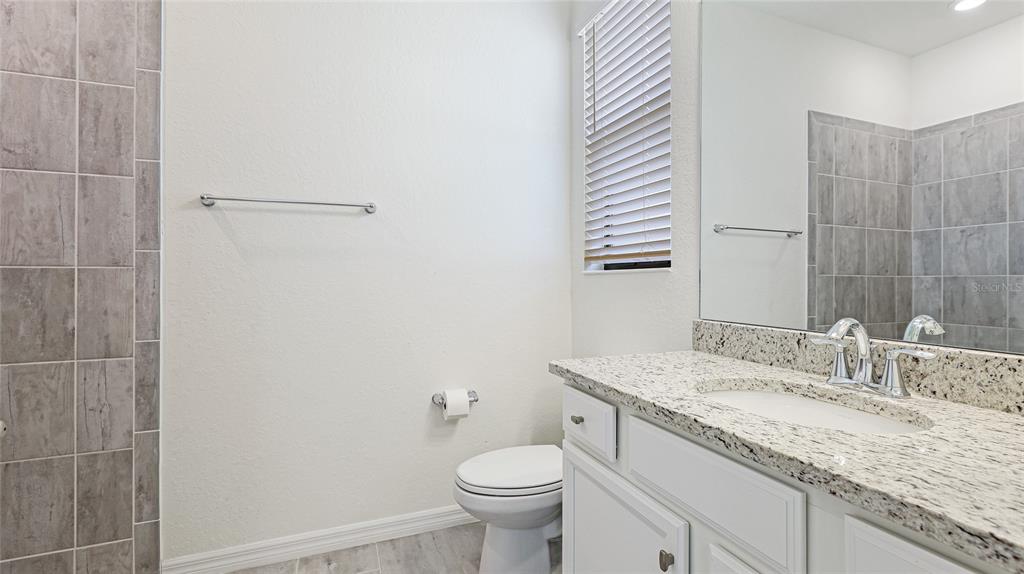 17311 Blue Ridge Place Bradenton, FL 34211 - Photo 23 of 55 a bathroom with a granite countertop sink toilet and shower
