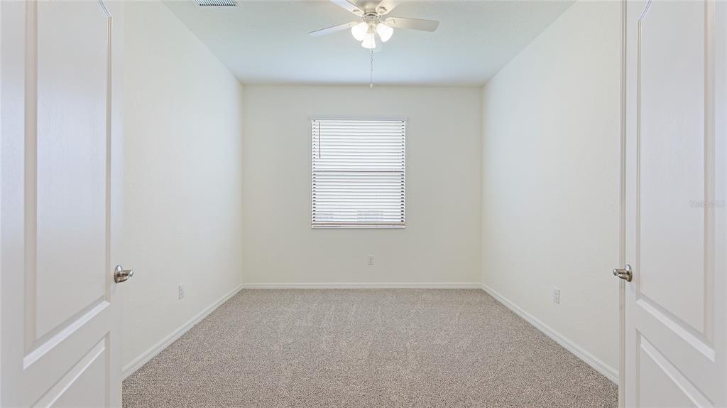 17311 Blue Ridge Place Bradenton, FL 34211 - Photo 25 of 55 an empty room with a window and a ceiling fan