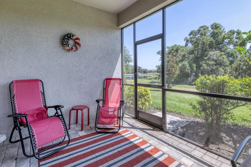 17311 Blue Ridge Place Bradenton, FL 34211 - Photo 32 of 55 a living room with furniture and a floor to ceiling window