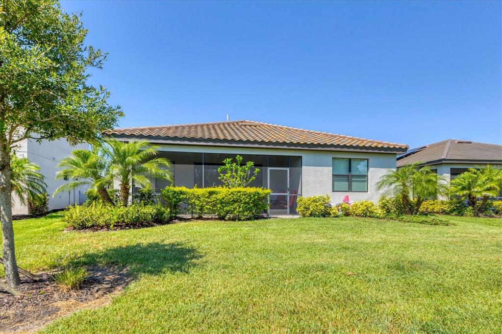 17311 Blue Ridge Place Bradenton, FL 34211 - Photo 37 of 55 a front view of a house with a yard and potted plants
