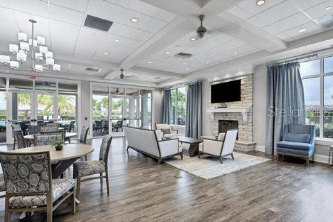 17311 Blue Ridge Place Bradenton, FL 34211 - Photo 46 of 55 a living room with furniture a fireplace and a chandelier