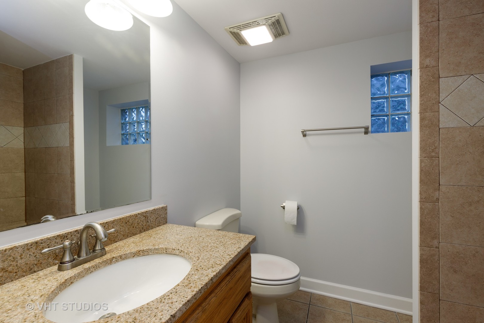 175 Barrypoint Road Riverside, IL 60546 - Photo 14 of 21 a bathroom with a granite countertop sink a mirror and a toilet