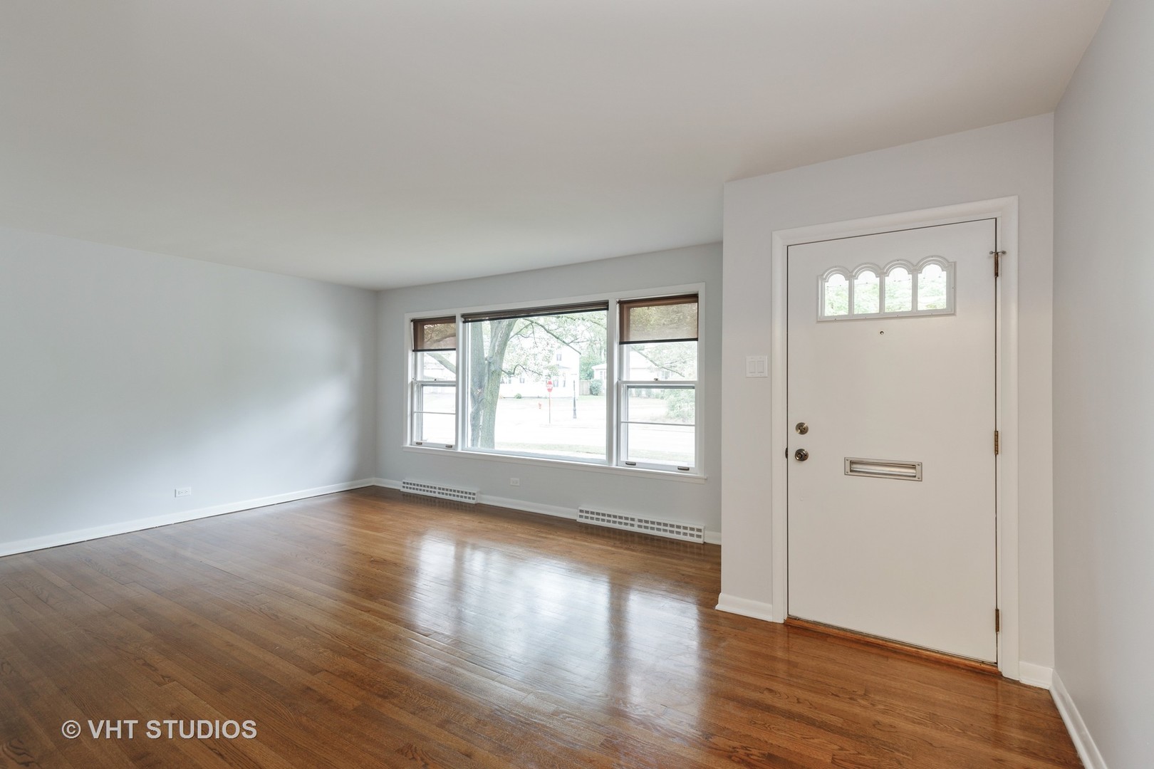 175 Barrypoint Road Riverside, IL 60546 - Photo 3 of 21 a view of an empty room with wooden floor and a window