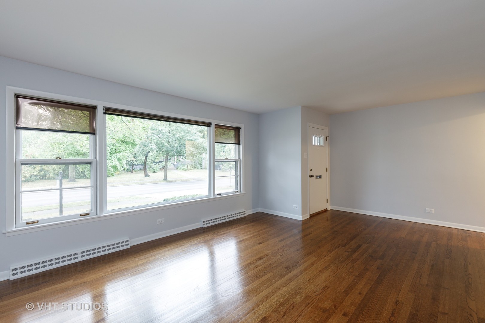 175 Barrypoint Road Riverside, IL 60546 - Photo 4 of 21 a view of an empty room with wooden floor and a window
