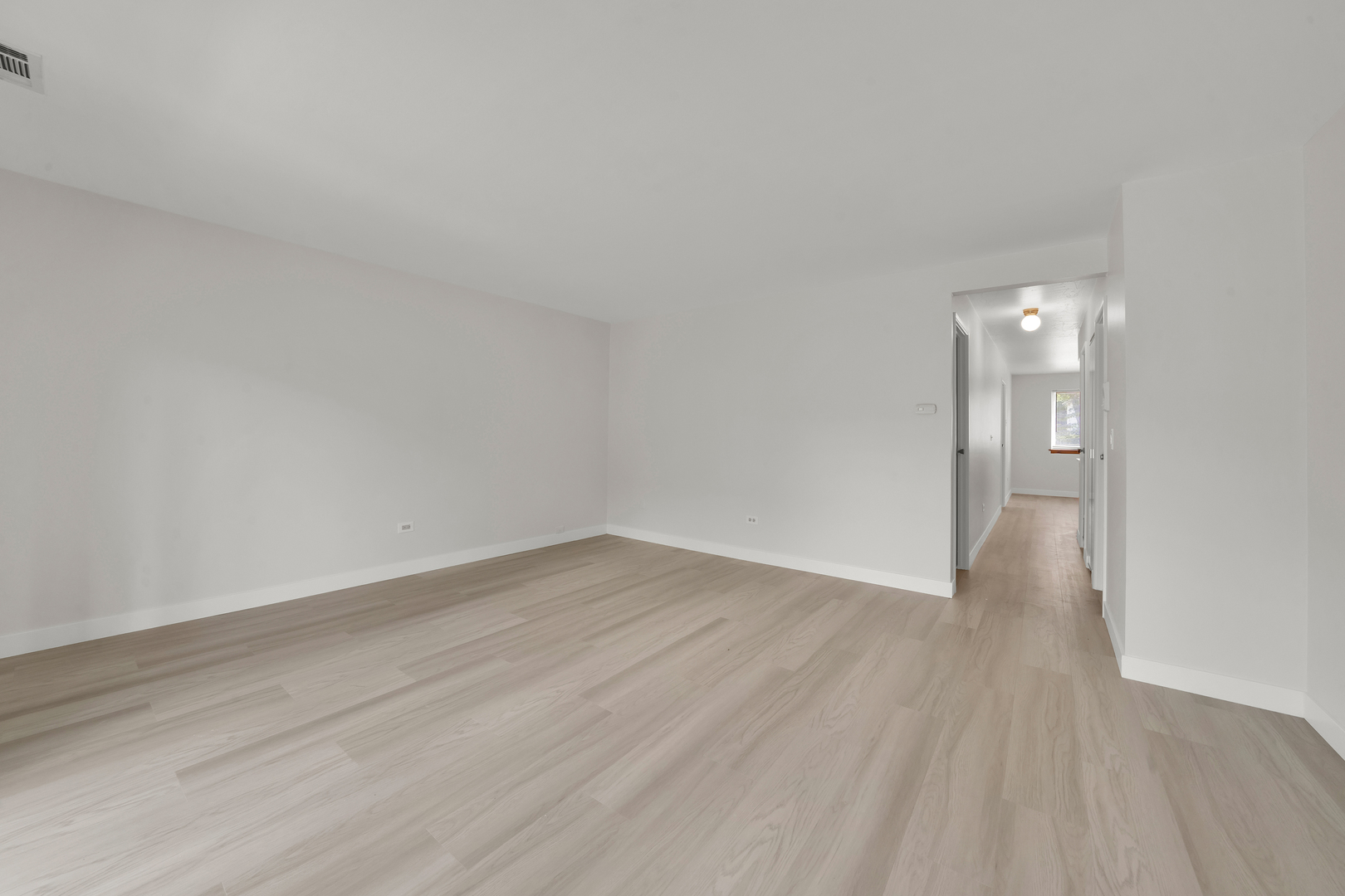 9615 Bianco Terrace, Unit 1A Des Plaines, IL 60016 - Photo 4 of 16 a view of an empty room and wooden floor