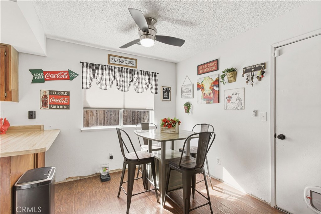 1418 Nut Tree Road Livingston, CA 95334 - Photo 21 of 33 a view of a dining room with furniture and wooden floor