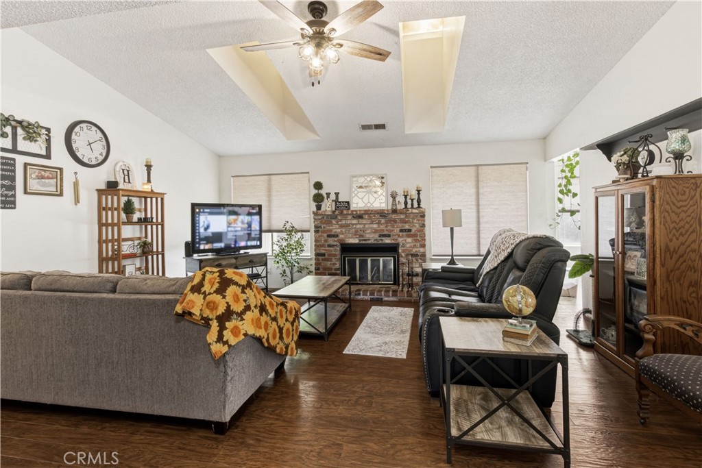 1418 Nut Tree Road Livingston, CA 95334 - Photo 9 of 33 a living room with furniture a fireplace and a flat screen tv