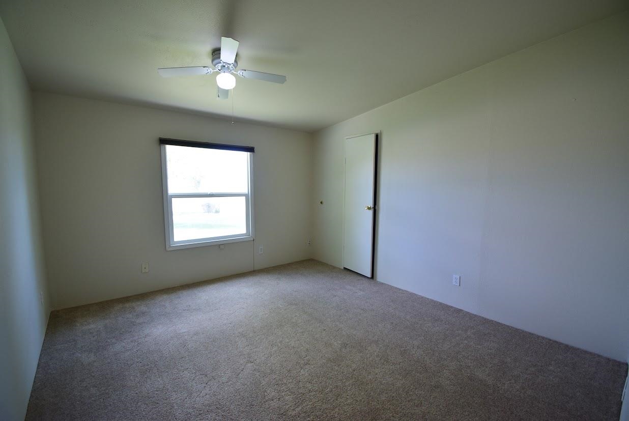 19548 B50 Road Delta, CO 81416 - Photo 19 of 37 an empty room with a window and a ceiling fan