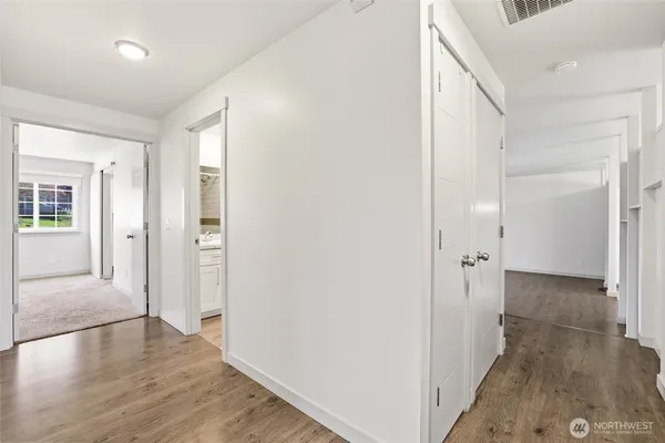 wooden floor with a chandelier
