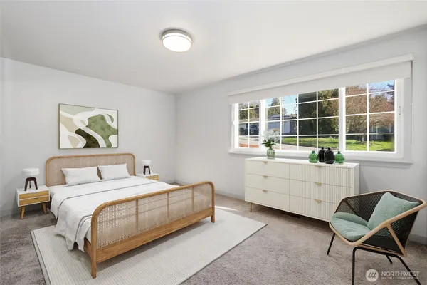 a bedroom with a bed and a large window