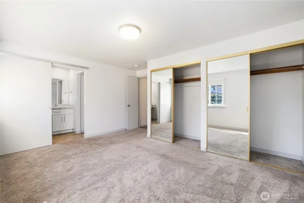 a view of an empty room with a kitchen