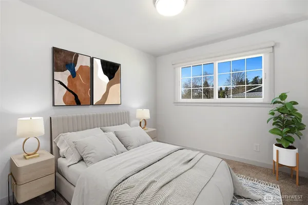 a bedroom with a bed and a potted plant
