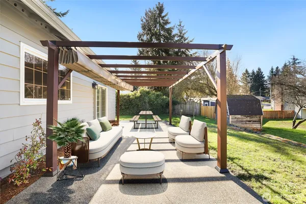 a view of a patio with couches chairs and potted plants