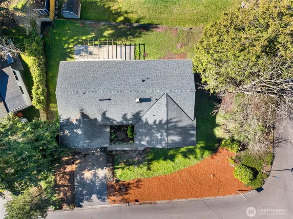 an aerial view of a house with a yard basket ball court and outdoor seating